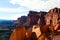 Panoramic view over bright shining red rocks on valley with isolated rugged table mountains