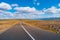 Panoramic view over Highland landscape in Iceland, with paved asphalt road at summer sunny day and blue sky with clouds