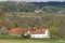 Panoramic view over hills, farm and blossom trees