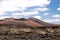 Panoramic view over lava field on crater and cone of red volcanoes in Timanfaya NP, Lanzarote, Canary Islands