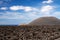 Panoramic view over lava field on crater and cone of red volcanoes in Timanfaya NP, Lanzarote, Canary Islands