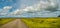 Panoramic view over lonely road through rough and colorful Icelandic landscape, Iceland, blue sky with beautiful clouds
