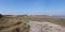 Panoramic view over pebble and marshy shoreline