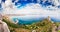 Panoramic view over the Sella del Diavolo promontory in Cagliari, with Poetto beach in background.