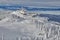 Panoramic view over the ski slope Poiana Brasov ski resort in Transylvania, Pine forest covered in snow on winter season,Mountain