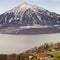 Panoramic view over Swiss Apls mountains near the Thun lake in w