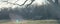 Panoramic view park in wintertime with bare tree and bench