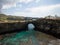 Panoramic view of Pasih Uug Broken beach tropical rock arch tunnel cliff cove natural bridge Nusa Penida Bali Indonesia