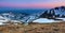 Panoramic view of the peacks of high mountains covered with snow, meadow with the rocks, amazing sunrise. Eco resort Carpathians.