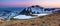 Panoramic view of the peacks of high mountains covered with snow, meadow with the rocks, amazing sunrise. Eco resort Carpathians