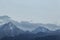 Panoramic view of the peaks of the Trans-Ili Alatau mountains in clear weather at blue hour.