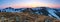 Panoramic view of the picks of high mountains covered with snow, meadow with the rocks, amazing sunrise. Eco resort Carpathians.