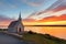 panoramic view of a picturesque seaside chapel at sunset