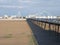 A panoramic view of the pier in southport merseyside with the beach at low tide on a bright summer day with the suspension bridge