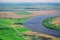 Panoramic view from the plane on the natural landscape: the river, the fields, the city