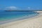 Panoramic view of Playa Carola white sand beach with lighthouse at the end of the beach San Cristobal Galapagos island