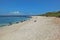 Panoramic view of Playa Carola white sandy beach with lighthouse at the end of the beach San Cristobal Galapagos island