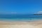 Panoramic view of Playa Carola white sandy beach with lighthouse at the end of the beach San Cristobal Galapagos island