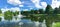 Panoramic view pond with water fountain in small American neighborhood