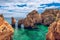 Panoramic view, Ponta da Piedade near Lagos in Algarve, Portugal. Cliff rocks and tourist boat on sea at Ponta da Piedade, Algarve