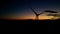 Panoramic view of a power generating wind farm during sunset