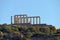 Panoramic view of the remains of a Greek temple dedicated to Poseidon, on the cape of Cape Sunio, located on the southern tip of