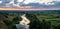 Panoramic view of river between fields during sundown