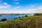 Panoramic view of the road bridge over big river and hills, slopes, steppe coast, gully, ravine on a banks