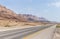 Panoramic view of the road,  coast of Dead Sea and mountains in the Judean Desert in the Dead Sea region in Israel