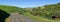 Panoramic view of a road through rolling hills with native bushland