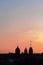 Panoramic view of the roofs, towers, domes of churches and cathedrals silhouetted against sunset light on spring evening