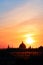 Panoramic view of the roofs, towers, domes of churches and cathedrals silhouetted against sunset light on spring evening