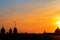 Panoramic view of the roofs, towers, domes of churches and cathedrals silhouetted against sunset light on spring evening