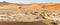 Panoramic view of sand-dunes in the Sossusvlei Nature Reserve in Namibia. These reddish dunes at the main `vlei` pan are massive