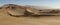 Panoramic view of sand-dunes in the Sossusvlei Nature Reserve in Namibia. These reddish dunes at the main `vlei` salt pan are m