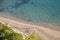 Panoramic view of sandy beach, cliffs, sea and blue sky.