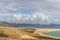 Panoramic view at sandy beach of Risco del Paso on canary island Fuerteventura with  turquoise water and mountain range in the