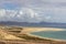 Panoramic view at sandy beach of Risco del Paso on canary island Fuerteventura with  turquoise water and mountain range in the