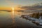 Panoramic view of Scenic Winter Sunset Reflections From Iced Sea to part of small stony peninsula Kont, Umea, Sweden. Winter