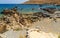 Panoramic view of the sea, deserted coast and and heaps of stones in the distance on summer day island Crete, Greece