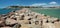 Panoramic view of the seaside with a stone breakwater. La Pineda, Spain