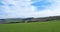 Panoramic view of sheep and new spring lambs grazing in fields surrounded by stone walls and hills in west yorkshire pennine