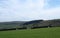 Panoramic view of sheep and new spring lambs grazing in fields surrounded by stone walls and hills in west yorkshire pennine