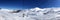 Panoramic view of ski resort, slope, people on the ski lift, skiers on the piste in Valle Nevado