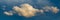 Panoramic view on Sky with dramatic fluffy clouds. White clouds on the sky suitable for background. Cloudy sky. Overcast