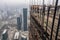 panoramic view of skyscrapers with scaffolding and construction workers visible