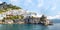 Panoramic view of small haven of Amalfi village with turquoise sea and colorful houses on slopes of Amalfi Coast with Gulf of