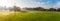 Panoramic view at small, local football pitch surrounded by trees. Football gates placed on the grass. Beautiful, foggy, autumn