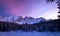 Panoramic view of snow covered lake carezza lago di carezza, karersee and latemar in winter; unesco world heritage, dolomites