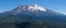 Panoramic view of the snow covered summit of Shasta mountain on a sunny summer day, California